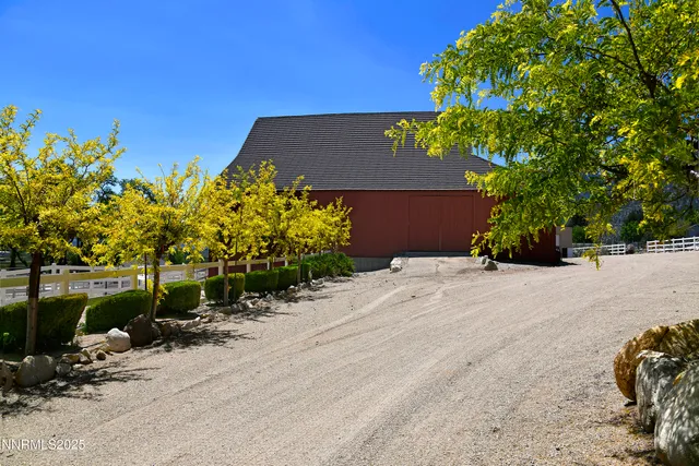 a living room with furniture a flat screen tv and a large window
