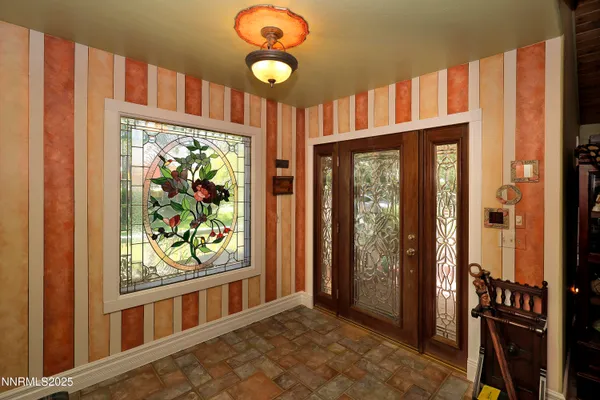 a kitchen with granite countertop lots of clutter and stainless steel appliances