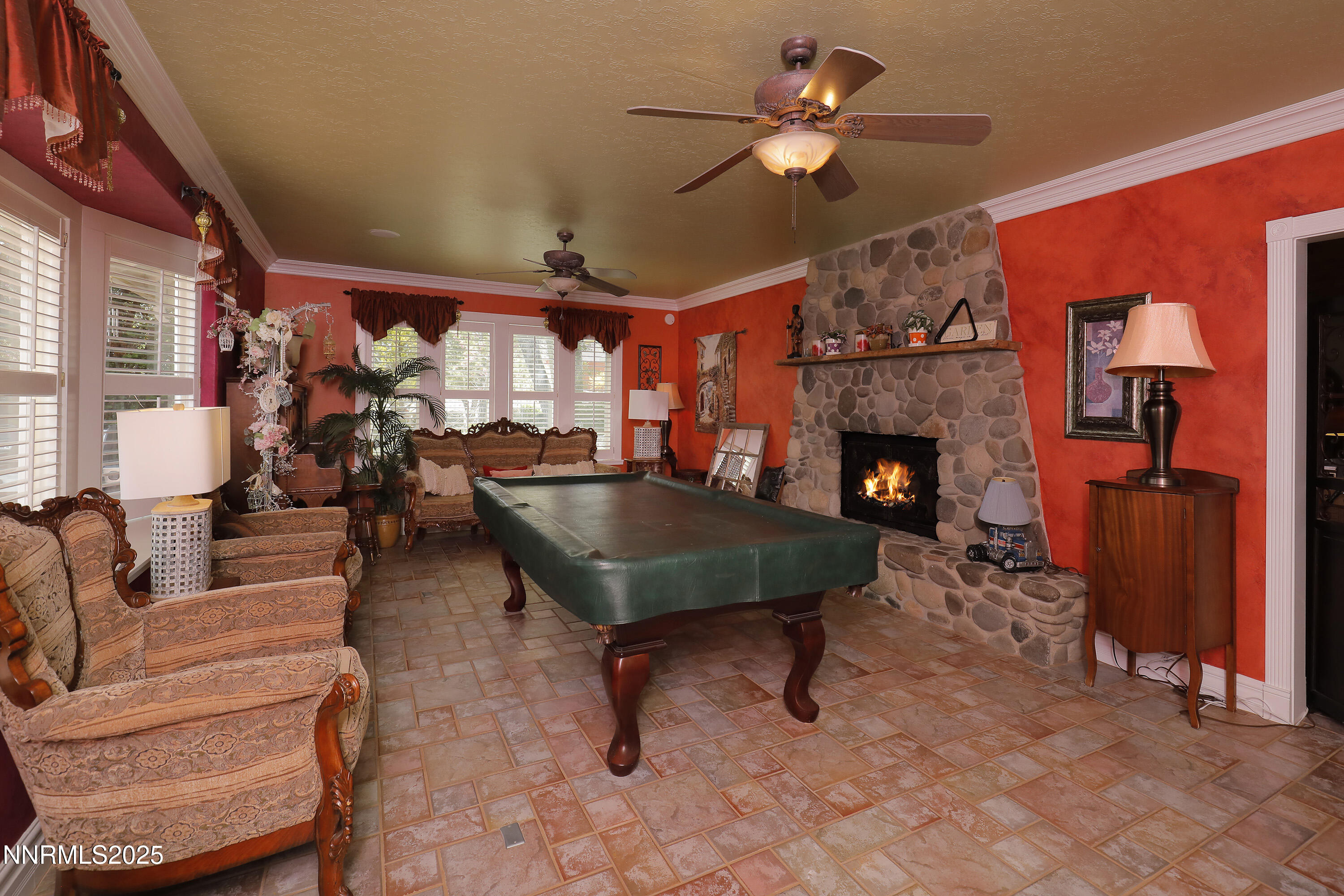 775 Foothill Road Gardnerville, NV 89460 - Photo 38 of 90 a living room with furniture a fireplace and a flat screen tv