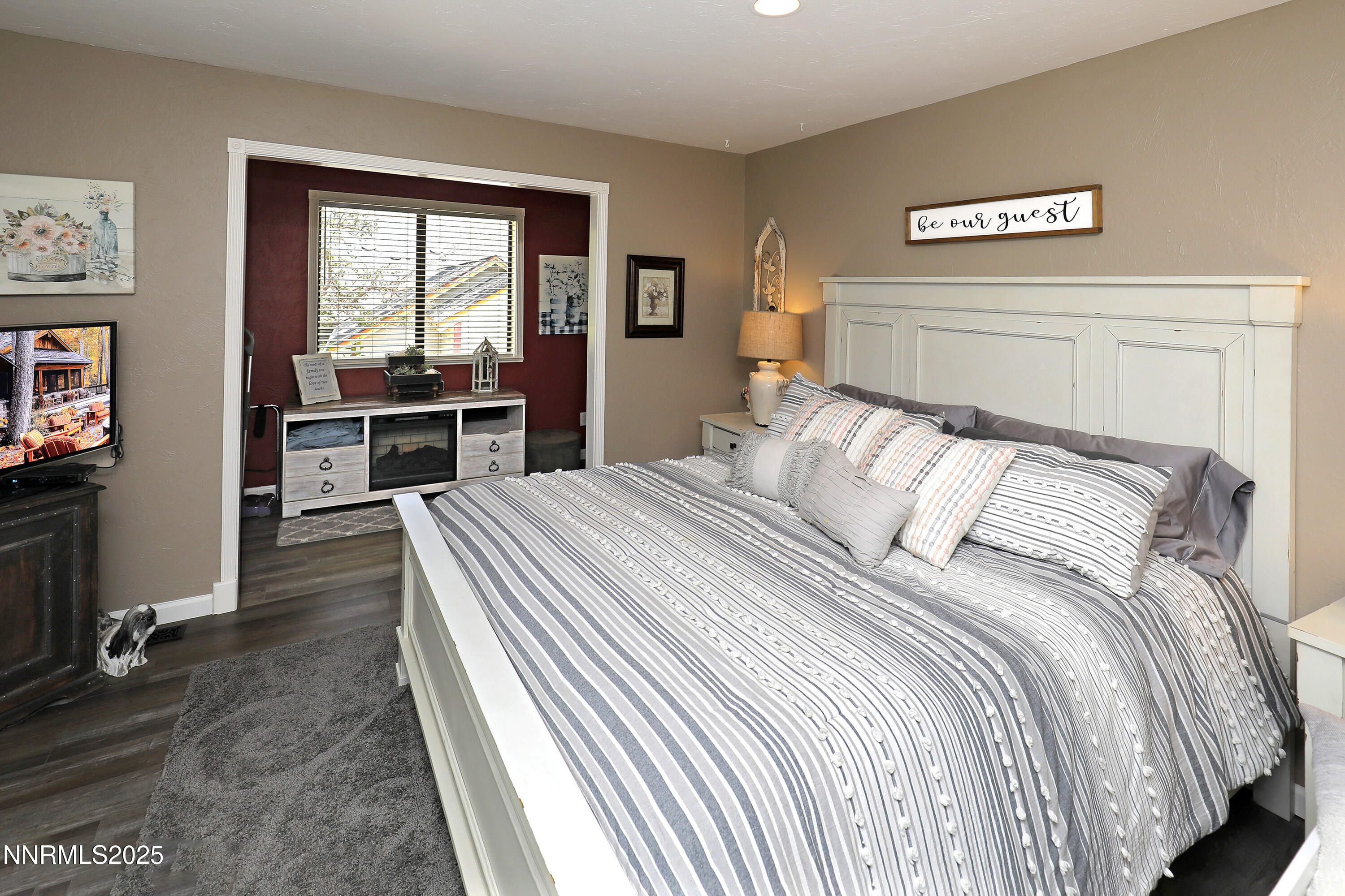 775 Foothill Road Gardnerville, NV 89460 - Photo 64 of 90 a bedroom with a balcony a bed and a tv on table