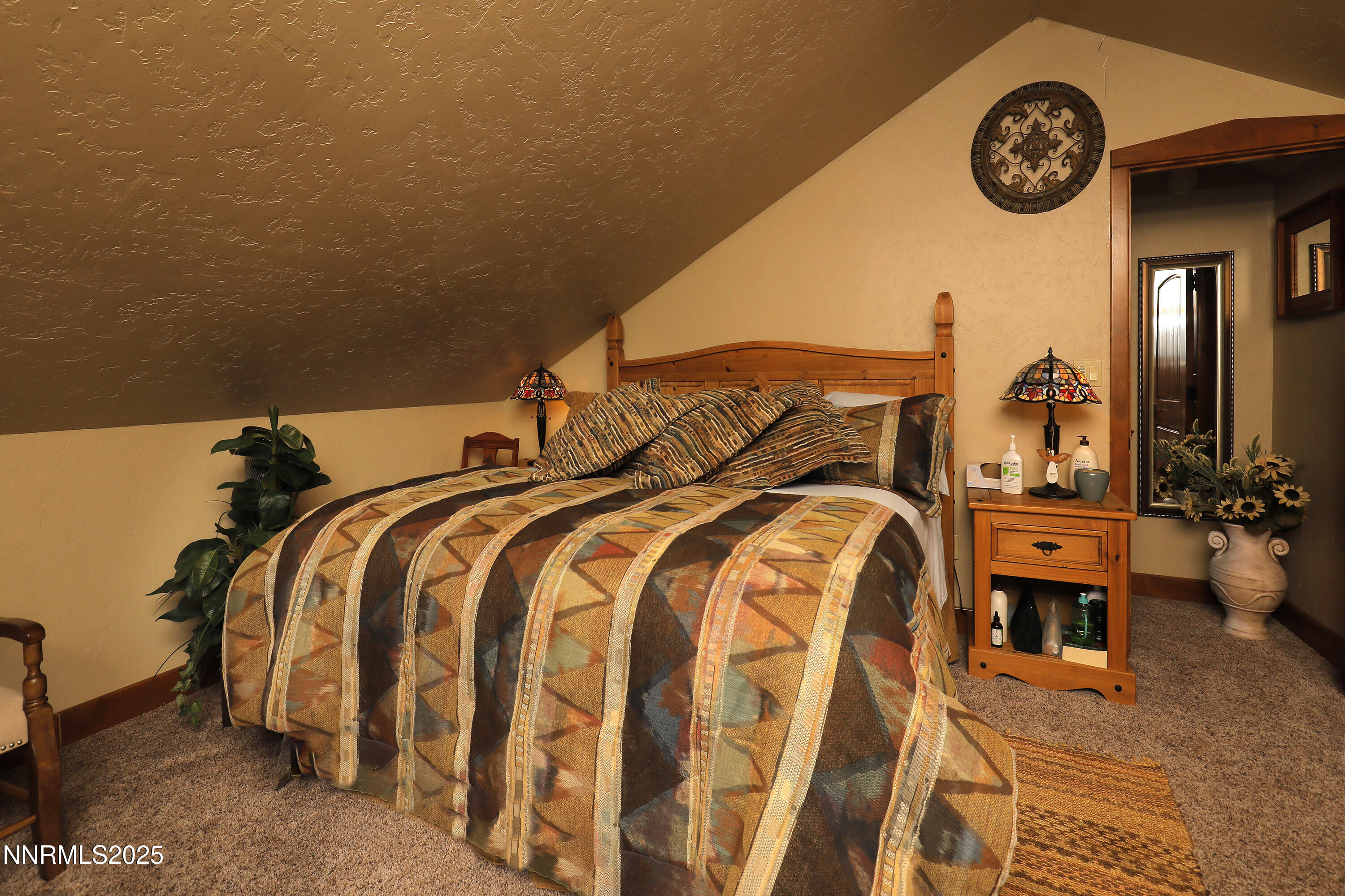 775 Foothill Road Gardnerville, NV 89460 - Photo 76 of 90 a bed room with a bed and a chandelier