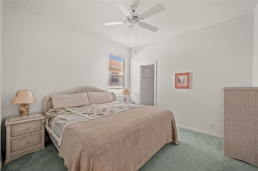 4333 Spicetree Street Venice, FL 34293 - Photo 21 of 29 a bedroom with a bed and a chandelier