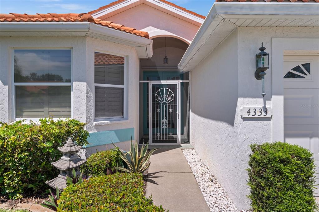 4333 Spicetree Street Venice, FL 34293 - Photo 3 of 29 a front view of a house with garden