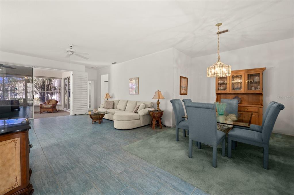 4333 Spicetree Street Venice, FL 34293 - Photo 4 of 29 a living room with furniture and a chandelier