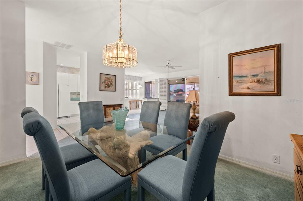 4333 Spicetree Street Venice, FL 34293 - Photo 6 of 29 a view of a dining room with furniture a chandelier and wooden floor