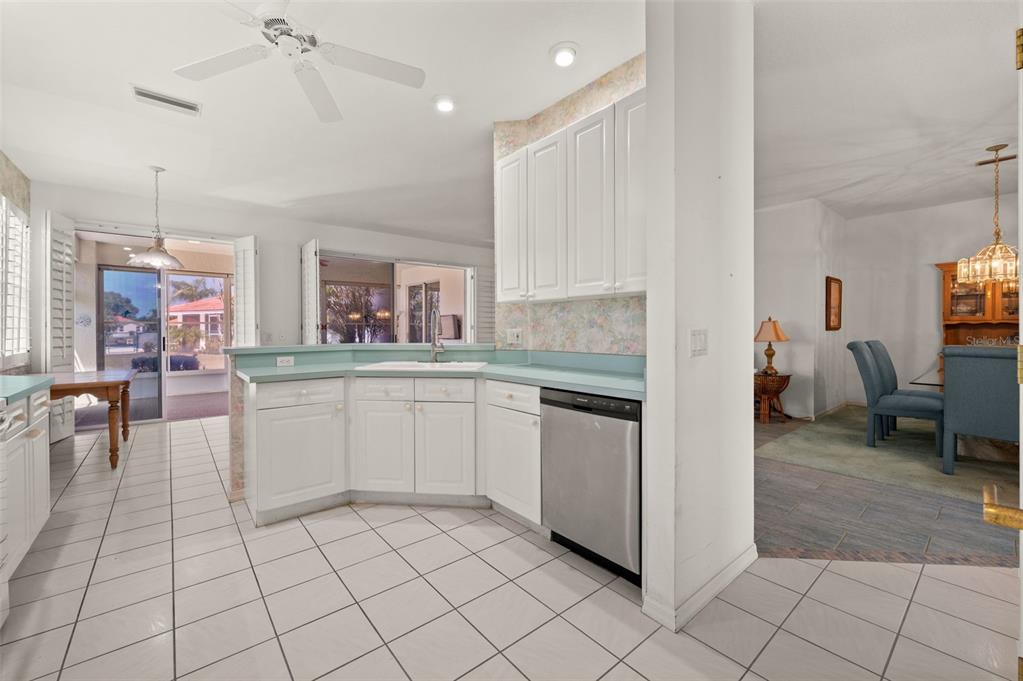 4333 Spicetree Street Venice, FL 34293 - Photo 10 of 29 a kitchen with cabinets and chairs