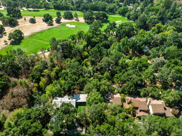 an aerial view of a house with a yard