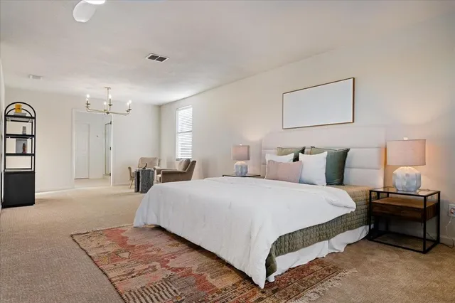 a bedroom with a bed and a chandelier