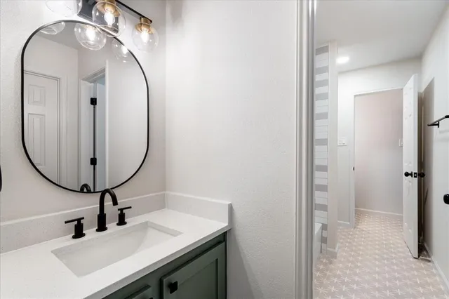 an empty room with windows and ceiling fan