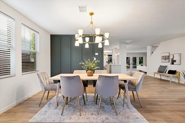 a living room with furniture and a dining table