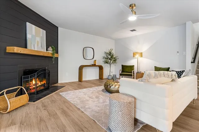 a living room with furniture and a potted plant