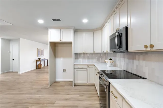 a living room with furniture a rug and a wooden floor