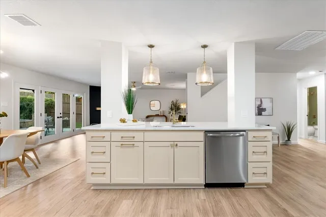 a kitchen with cabinets and wooden floor