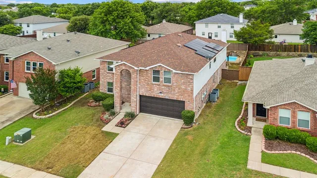 an aerial view of residential houses with outdoor space and street view
