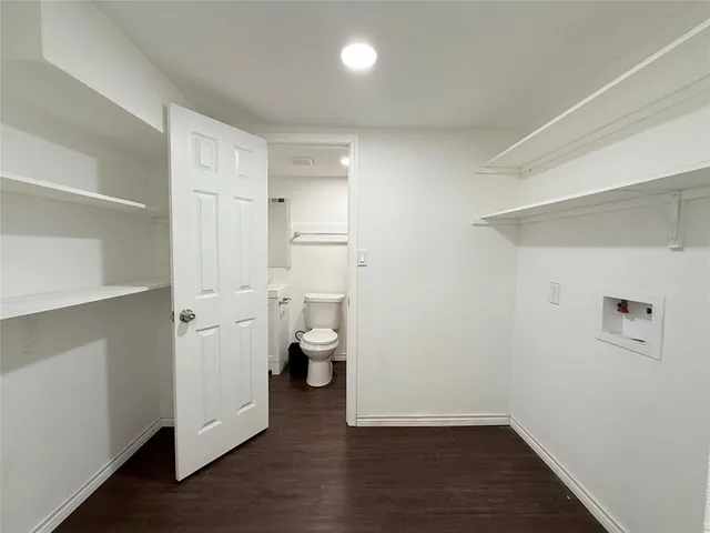 a view of bathroom with a toilet a sink and a mirror