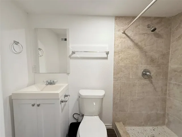 a white toilet sitting next to a bathroom sink