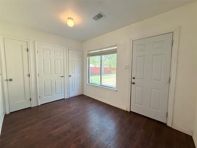 a view of a livingroom with wooden floor and a window