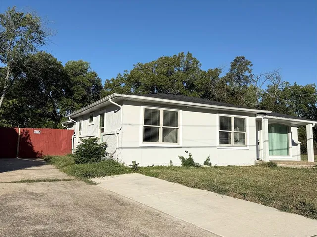 a front view of a house with a yard and a garage