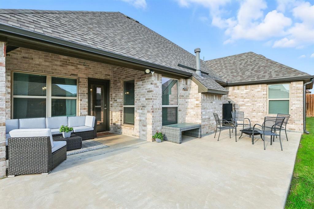 705 Chaparral Road Sanger, TX 76266 - Photo 34 of 38 a view of a patio with table and chairs