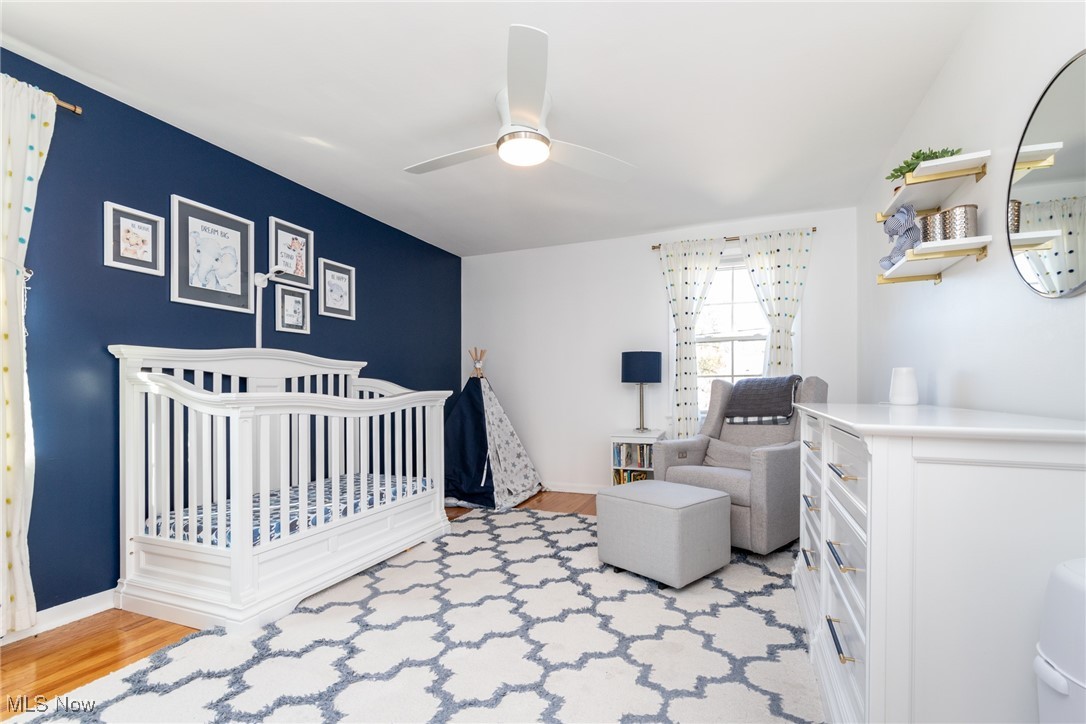 2536 Traymore Road Cleveland, OH 44118 - Photo 23 of 29 Bedroom with a crib, light wood-type flooring, and ceiling fan