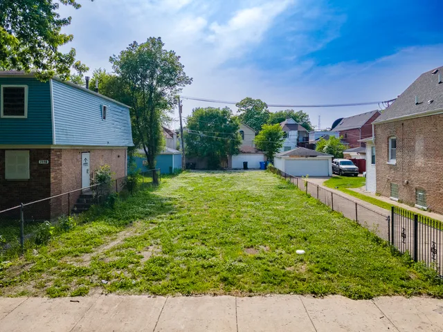 a view of a backyard with plants and a patio