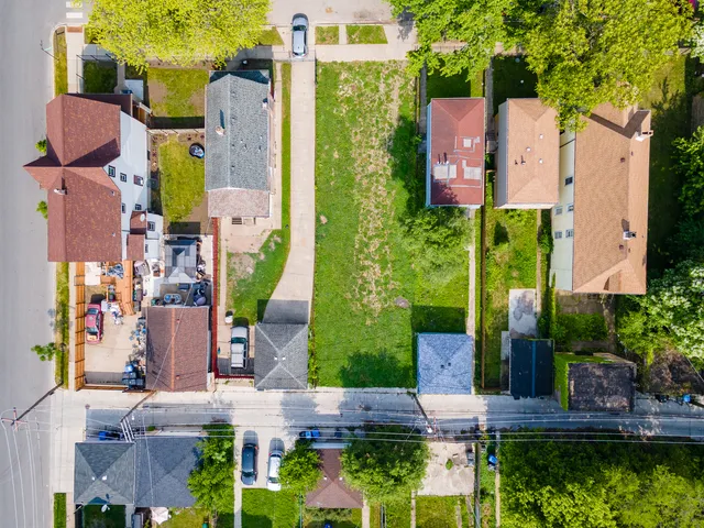 front view of house with a yard and plants