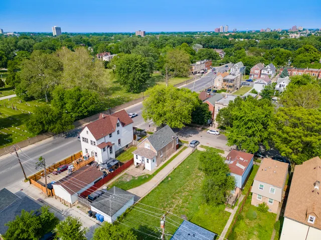 an aerial view of a house with a yard