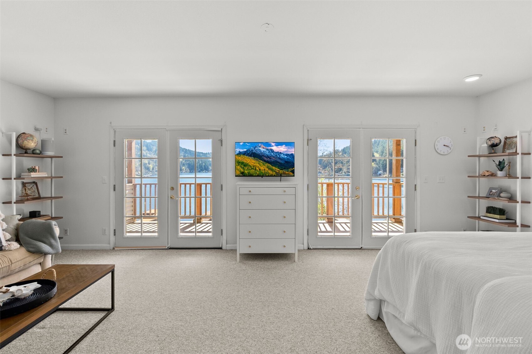 1521 Summit Lake Shore Road Northwest Olympia, WA 98502 - Photo 18 of 40 a bedroom with a bed a bookshelf and painting on the wall
