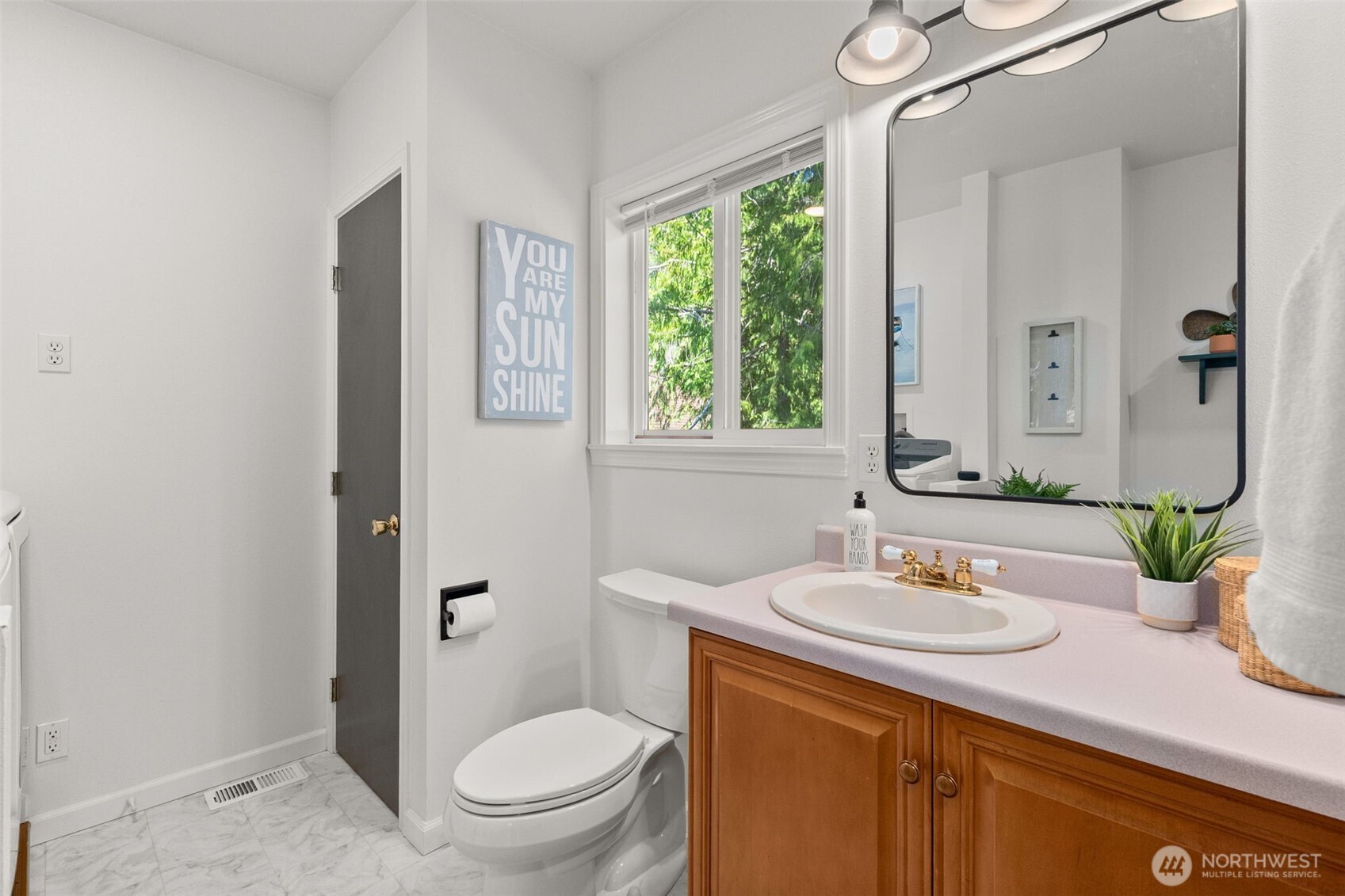 1521 Summit Lake Shore Road Northwest Olympia, WA 98502 - Photo 24 of 40 a bathroom with a sink a toilet and a mirror