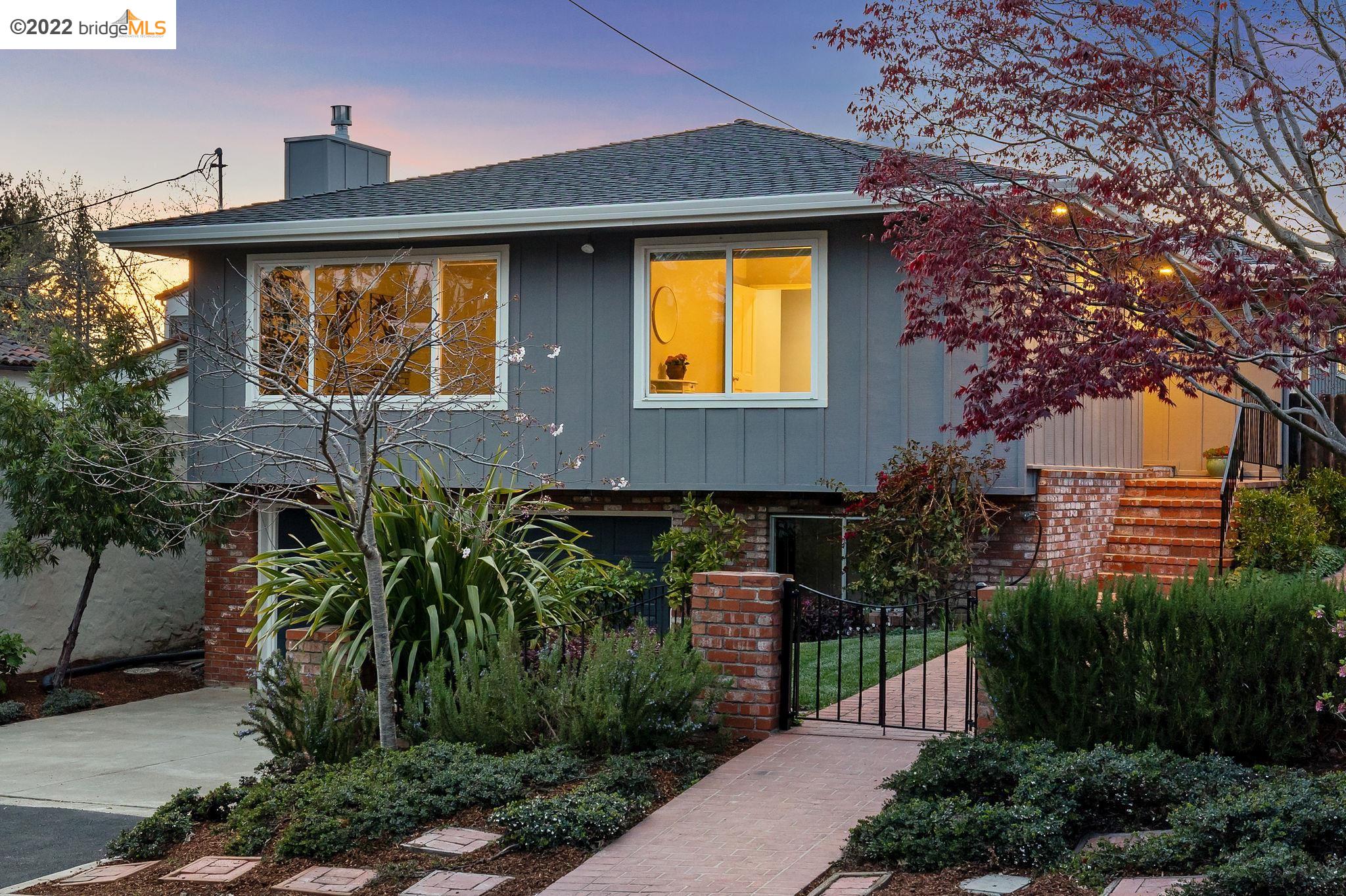 a front view of a house with a garden