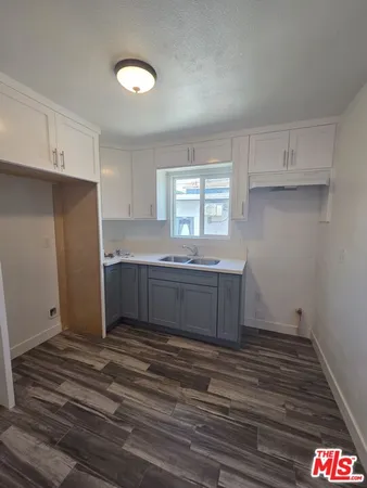 a kitchen with stainless steel appliances cabinets a sink and a window