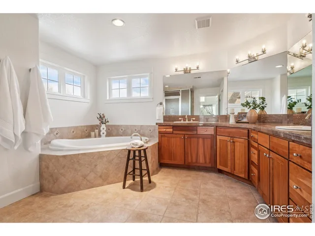 a spacious bathroom with a sink double vanity and a mirror