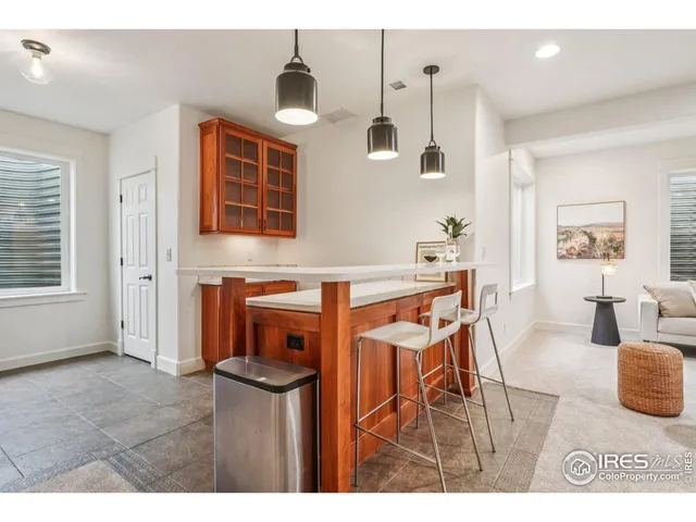 a living room with furniture a flat screen tv and a window