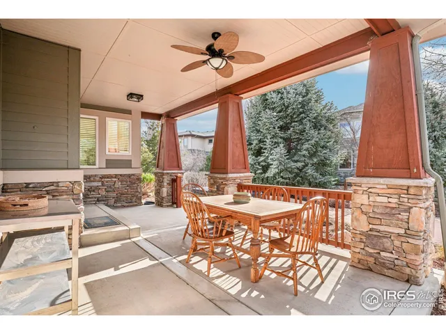 a very nice looking dining room with a large window and chandelier