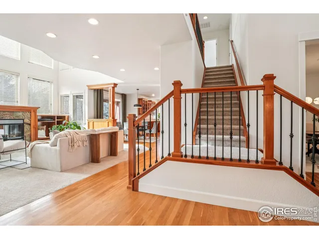 a view of a living room and kitchen with furniture wooden floor and windows