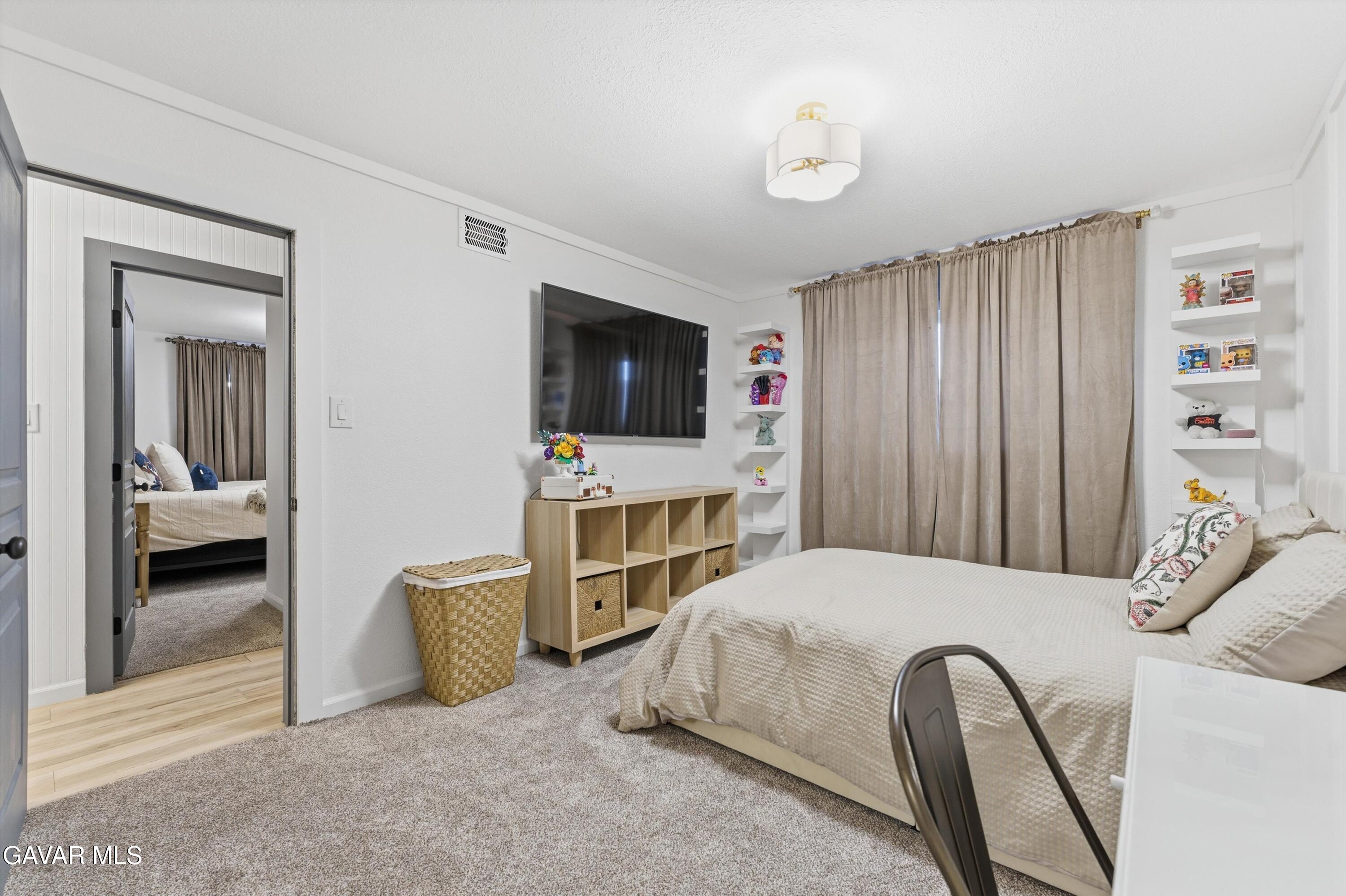 43851 Fern Avenue Lancaster, CA 93534 - Photo 15 of 20 a bedroom with a bed and a television