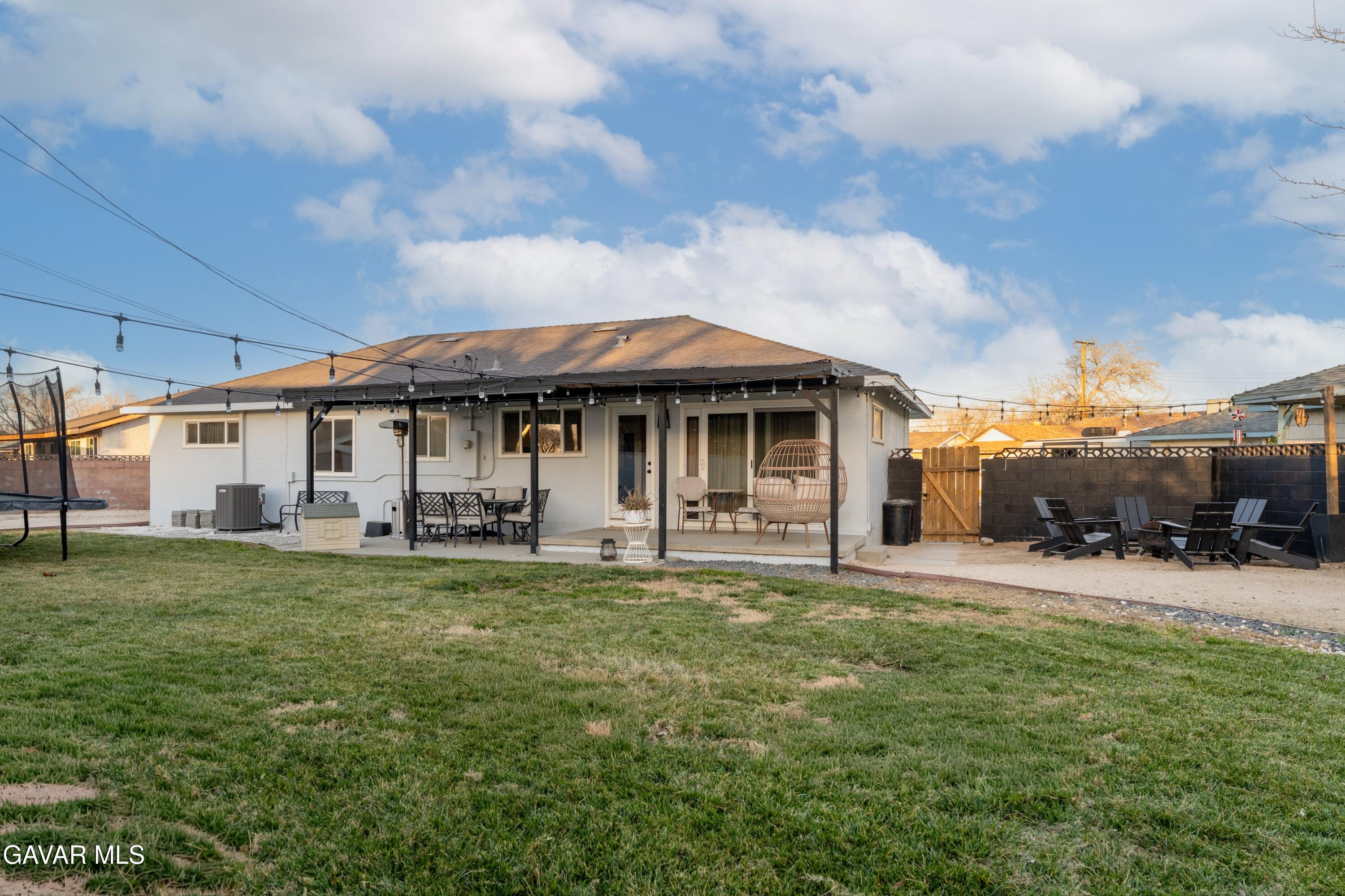 43851 Fern Avenue Lancaster, CA 93534 - Photo 19 of 20 a front view of a house with a garden and trees