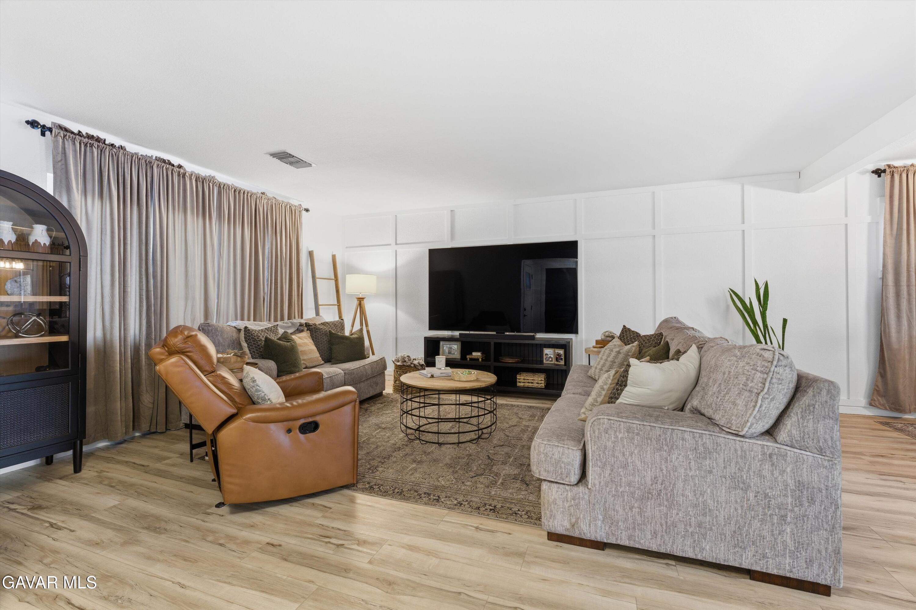 43851 Fern Avenue Lancaster, CA 93534 - Photo 2 of 20 a living room with furniture and a flat screen tv