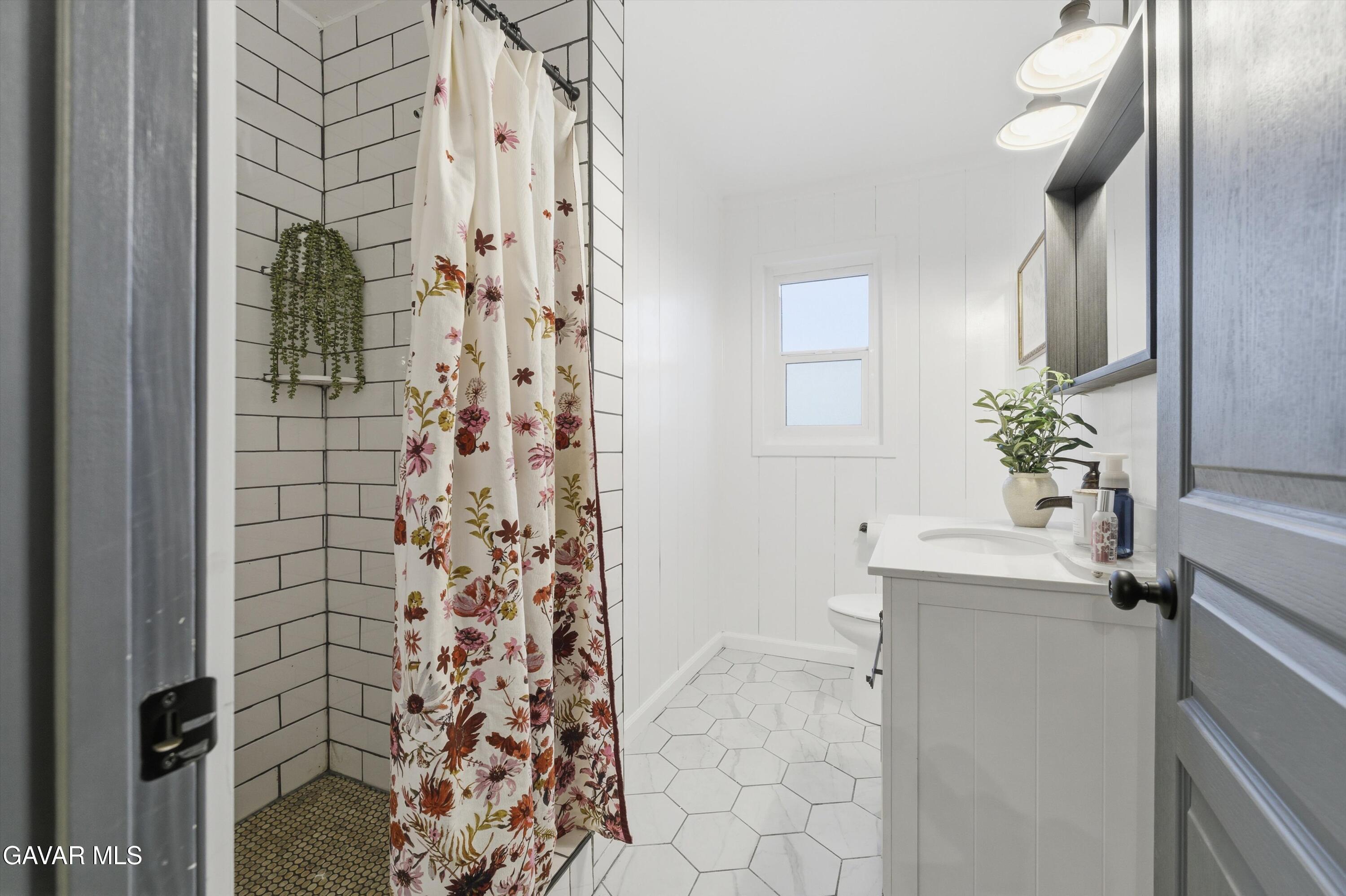 43851 Fern Avenue Lancaster, CA 93534 - Photo 7 of 20 a bathroom with a sink a mirror and a shower