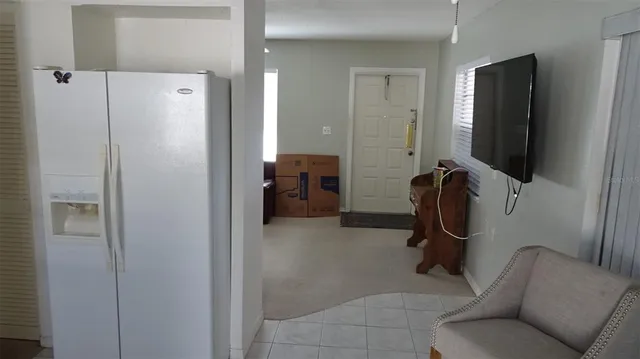 a view of a livingroom with furniture and a flat screen tv