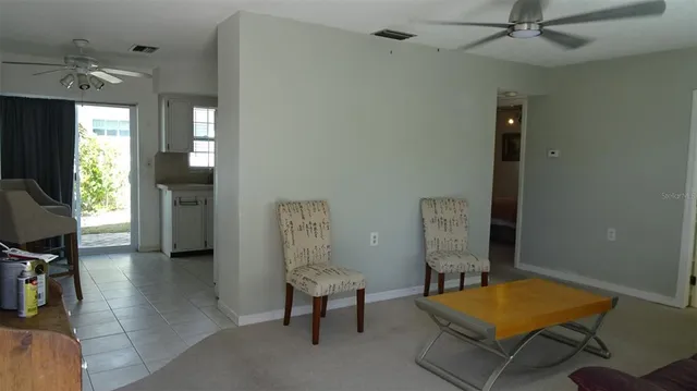 a living room with furniture and a pool table