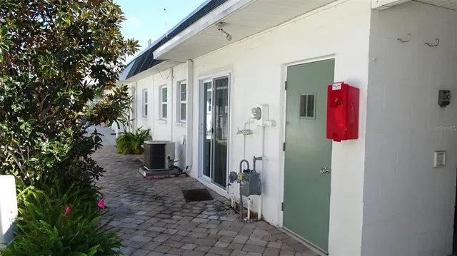 a backyard of a house with table and chairs