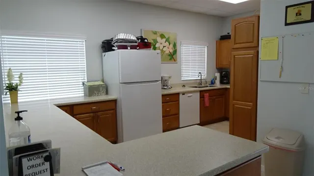 a dining room with furniture and a floor to ceiling window