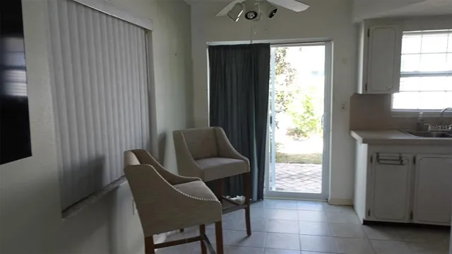 a view of a hallway with furniture and a window