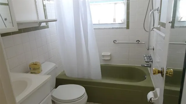 a bathroom with a sink a toilet and bathtub