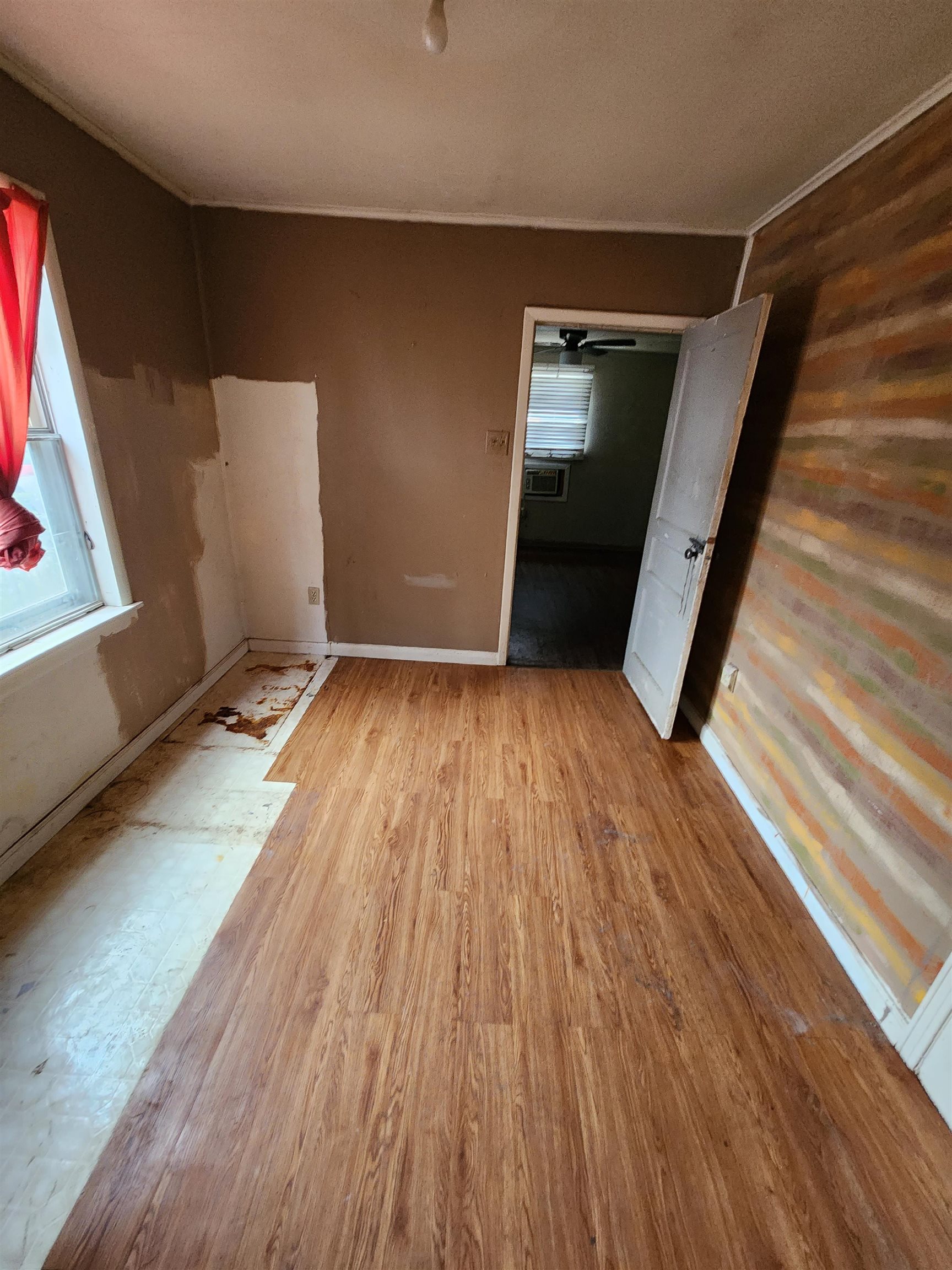 4170 Elliston Road Memphis, TN 38111 - Photo 17 of 19 a view of an empty room with wooden floor and a window