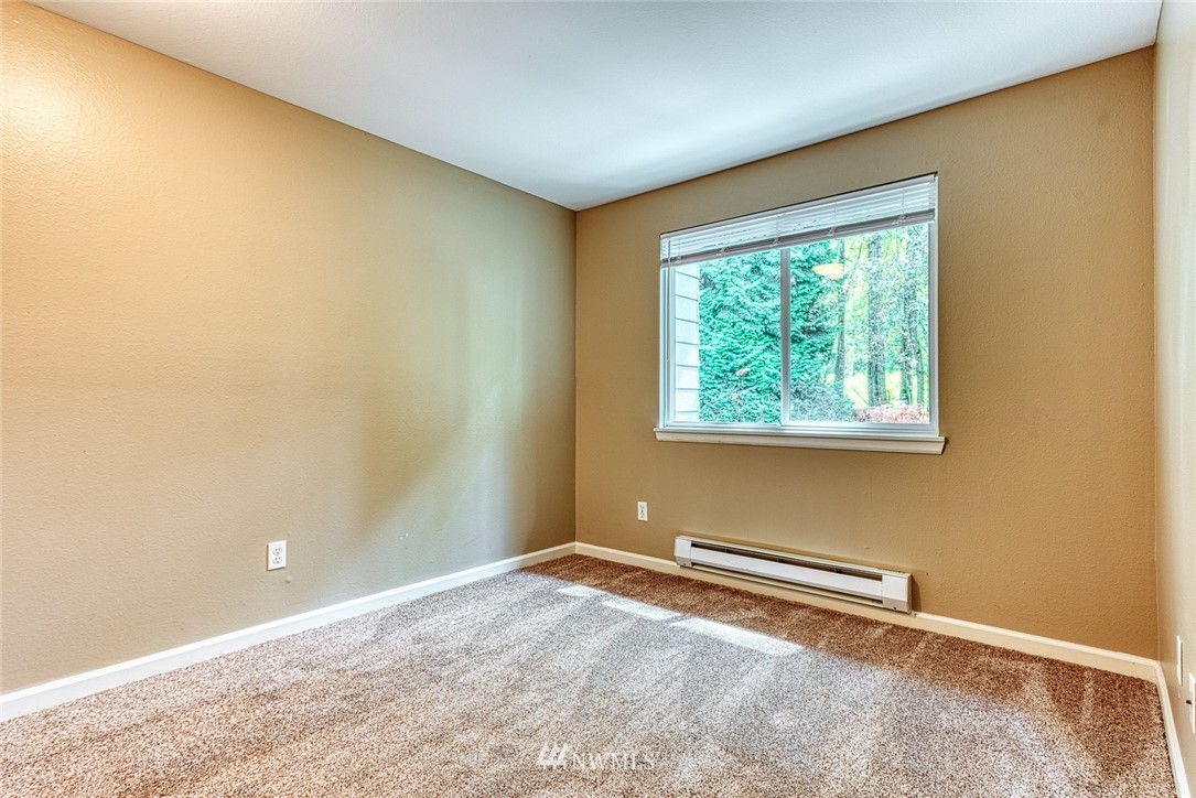 10831 Northeast 147th Lane, Unit R104 Bothell, WA 98011 - Photo 11 of 15 an empty room with a window