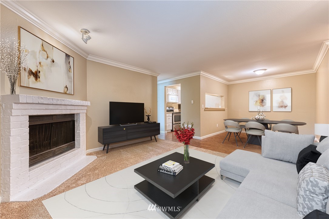 10831 Northeast 147th Lane, Unit R104 Bothell, WA 98011 - Photo 5 of 15 a living room with furniture a flat screen tv and a fireplace