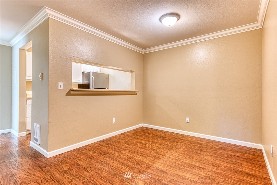 10831 Northeast 147th Lane, Unit R104 Bothell, WA 98011 - Photo 9 of 15 a view of a big room with wooden floor and windows