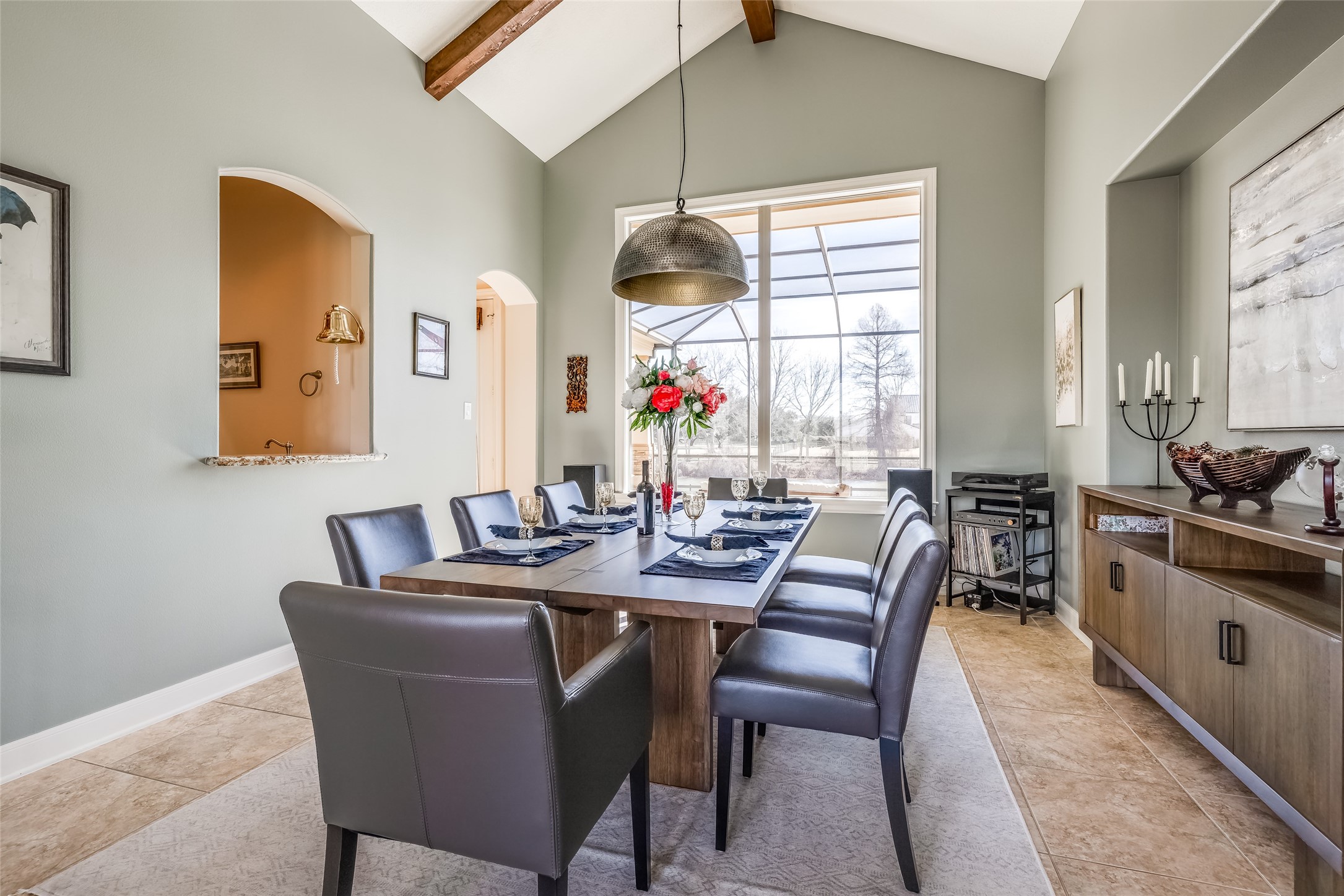31102 Lower Oxbow Trace Fulshear, TX 77441 - Photo 7 of 50 Beautiful large Dining Room with high ceiling, wooden ceiling beams, great views of pool & Oxbow Lake, tile floors, window through to wine room & bar